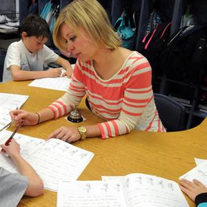 A teacher works with young students